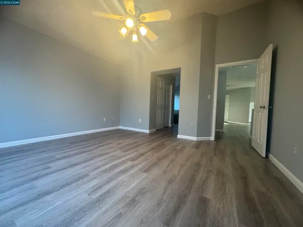 a view of empty room with wooden floor