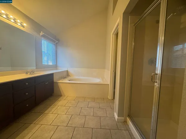 a bathroom with a bathtub sink vanity and a mirror