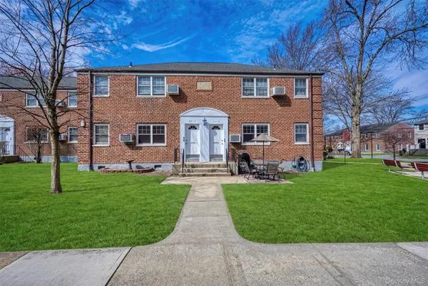 a front view of a house with a garden and patio