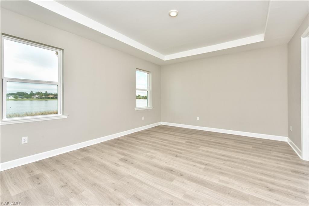 2066 Grove Drive Naples, FL 34120 - Photo 11 of 32 a view of an empty room with wooden floor and a window
