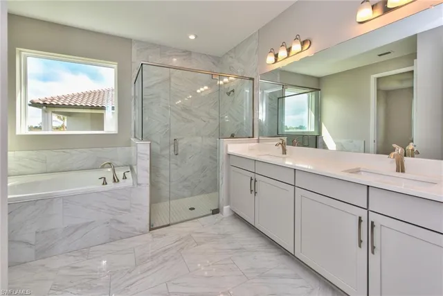 a bathroom with a double vanity sink and a bathtub