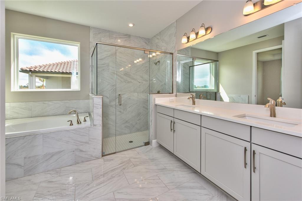 2066 Grove Drive Naples, FL 34120 - Photo 13 of 32 a bathroom with a double vanity sink and a bathtub