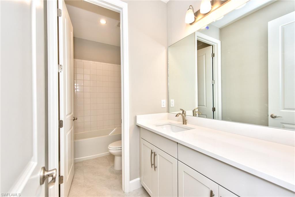2066 Grove Drive Naples, FL 34120 - Photo 18 of 32 a bathroom with a sink and a mirror
