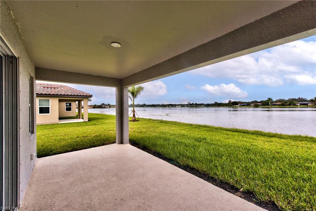 2066 Grove Drive Naples, FL 34120 - Photo 21 of 32 a view of a house with a yard and a large tree
