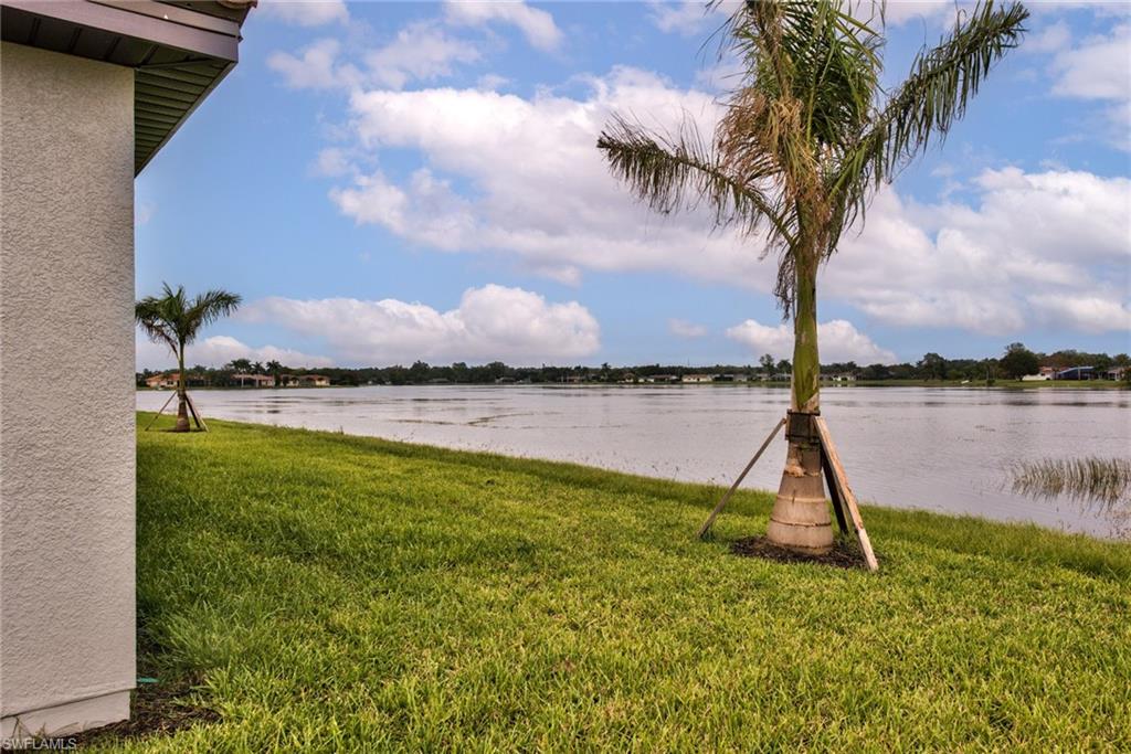2066 Grove Drive Naples, FL 34120 - Photo 22 of 32 a view of a lake with a big yard