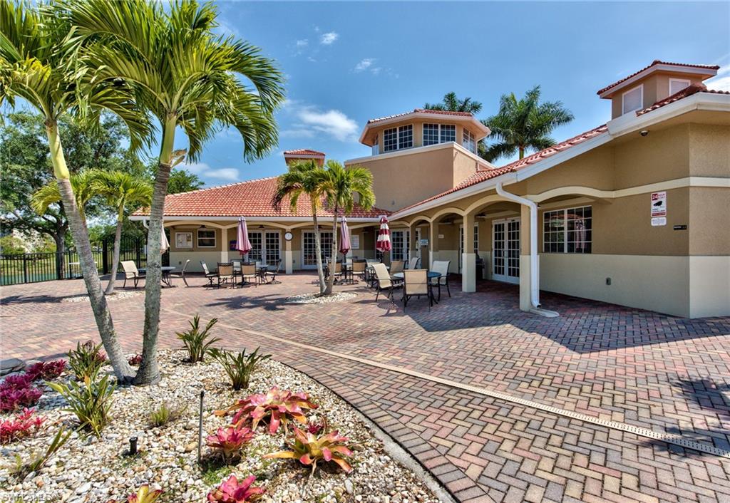 2066 Grove Drive Naples, FL 34120 - Photo 32 of 32 a view of a white house with a fountain in a patio
