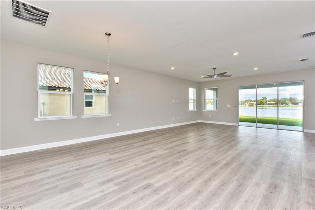 2066 Grove Drive Naples, FL 34120 - Photo 4 of 32 a view of an empty room with wooden floor and a window