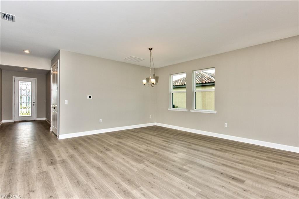 2066 Grove Drive Naples, FL 34120 - Photo 5 of 32 wooden floor in an empty room with a window