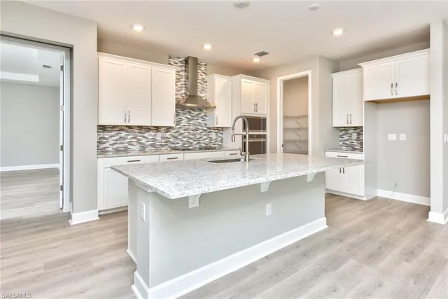 a kitchen with stainless steel appliances granite countertop a stove and a refrigerator