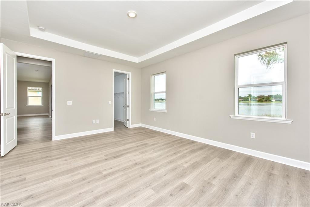 2066 Grove Drive Naples, FL 34120 - Photo 10 of 32 an empty room with wooden floor and windows