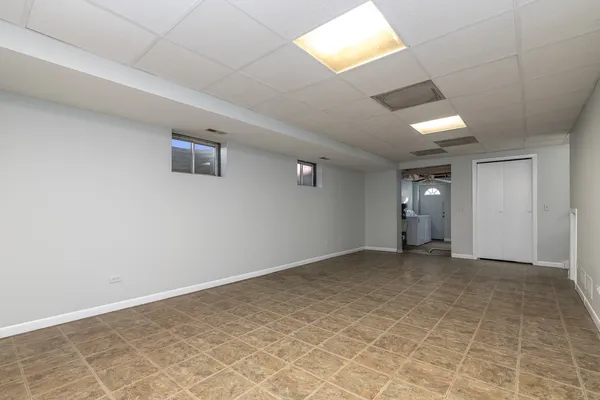 an empty room with closet and windows