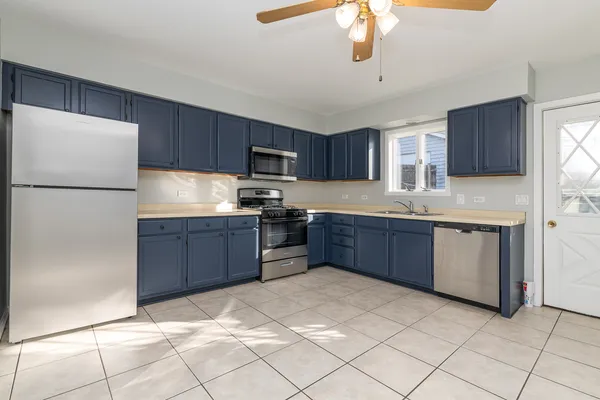 a kitchen with stainless steel appliances granite countertop a refrigerator sink and cabinets