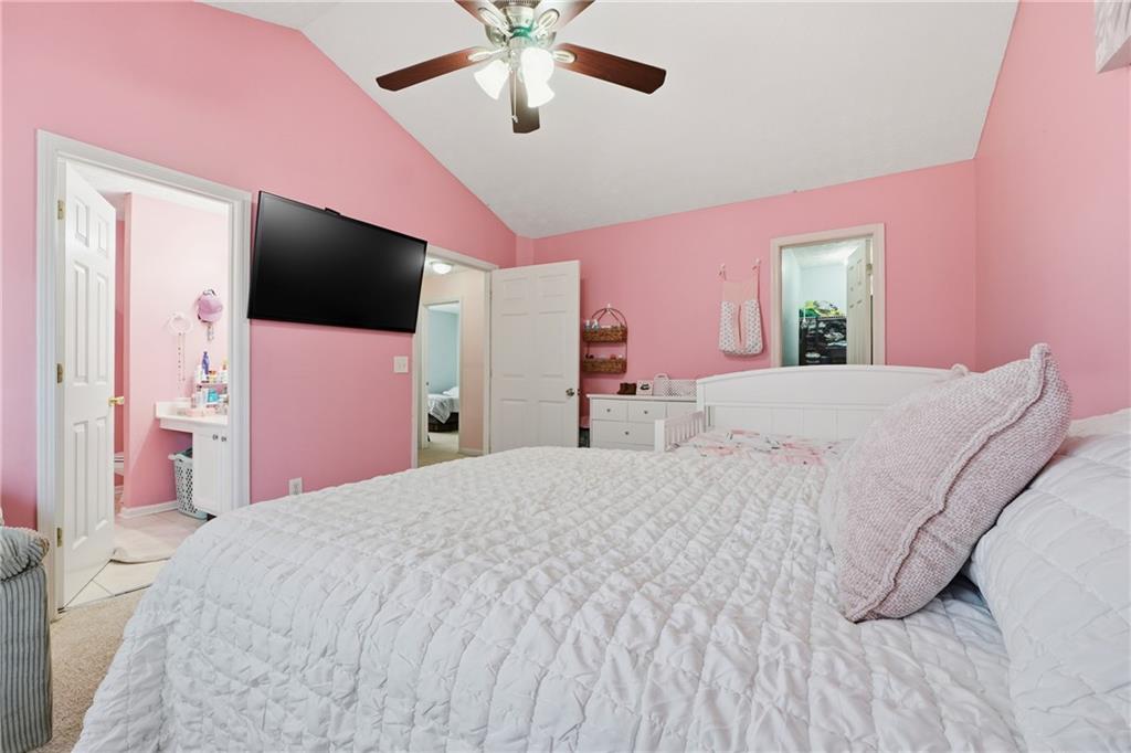 265 Springbottom Drive Southeast Lawrenceville, GA 30046 - Photo 14 of 30 a bedroom with a bed and a flat screen tv