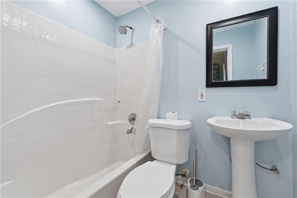 265 Springbottom Drive Southeast Lawrenceville, GA 30046 - Photo 22 of 30 a bathroom with a toilet a sink and mirror