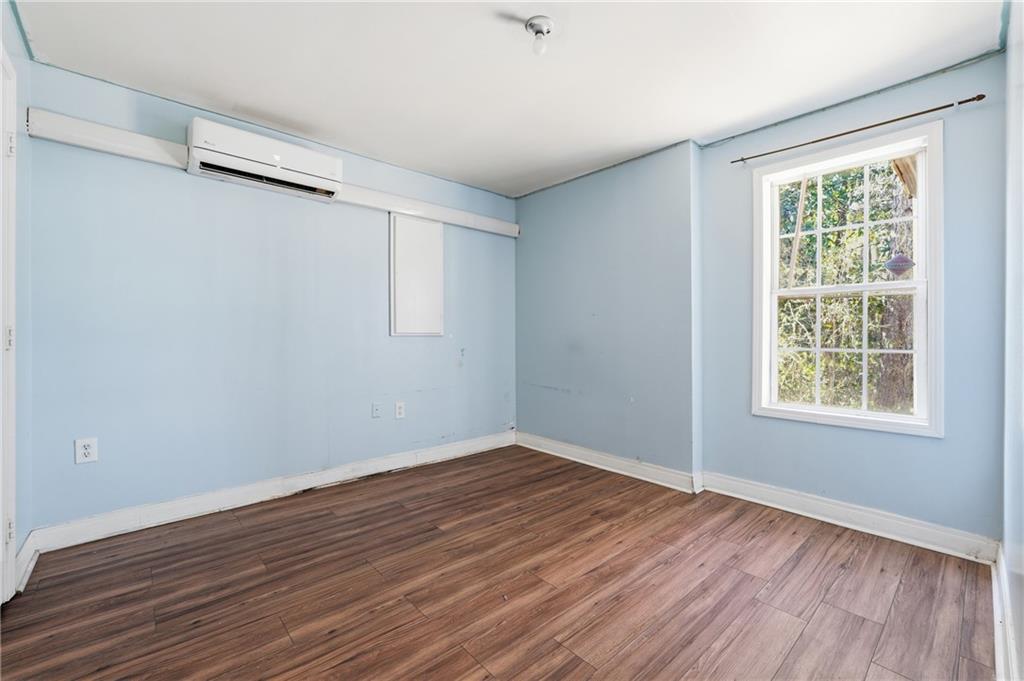 265 Springbottom Drive Southeast Lawrenceville, GA 30046 - Photo 24 of 30 an empty room with wooden floor and windows