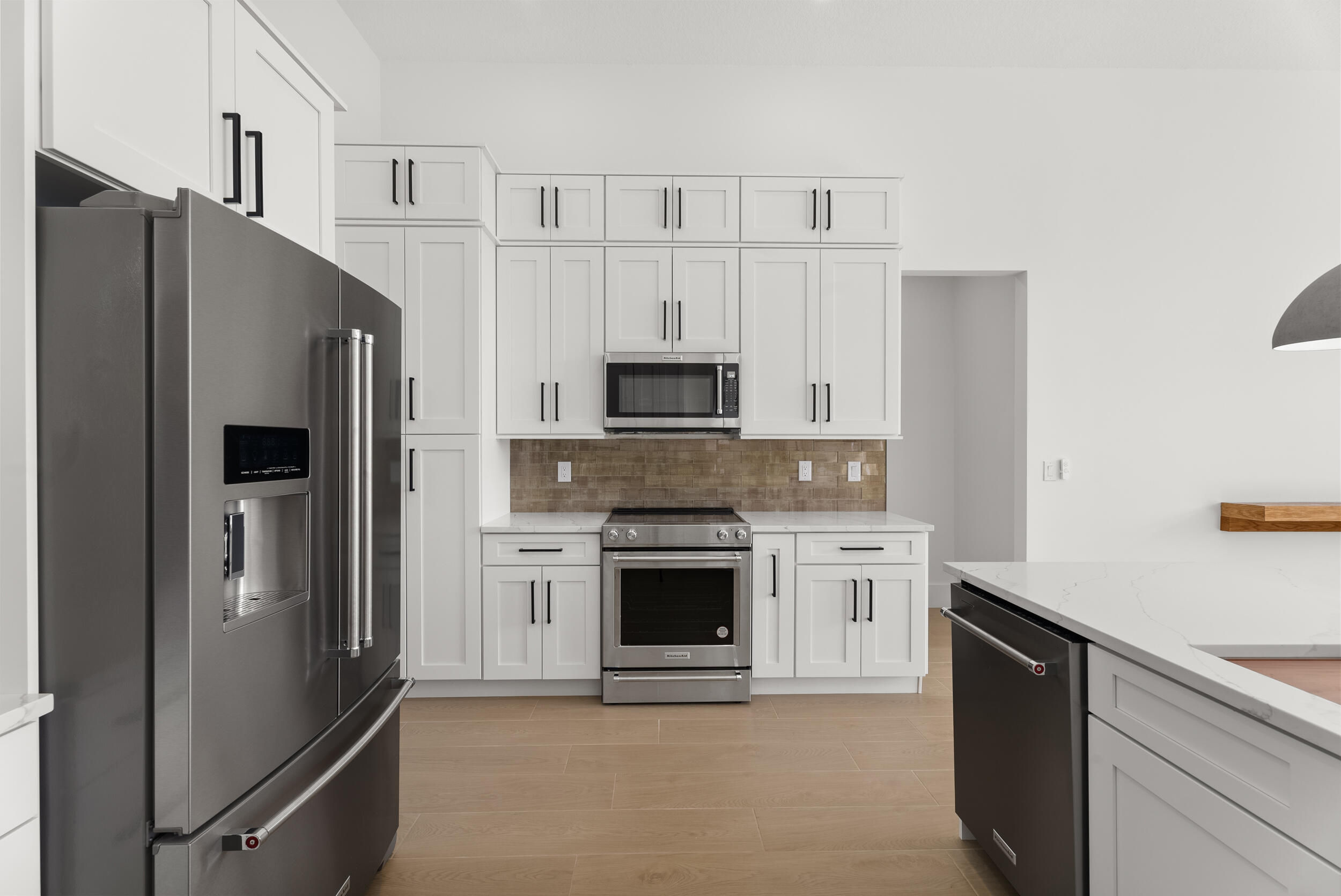2218 Southeast Stonehaven Road Port St. Lucie, FL 34952 - Photo 19 of 48 a kitchen with granite countertop white cabinets and stainless steel appliances