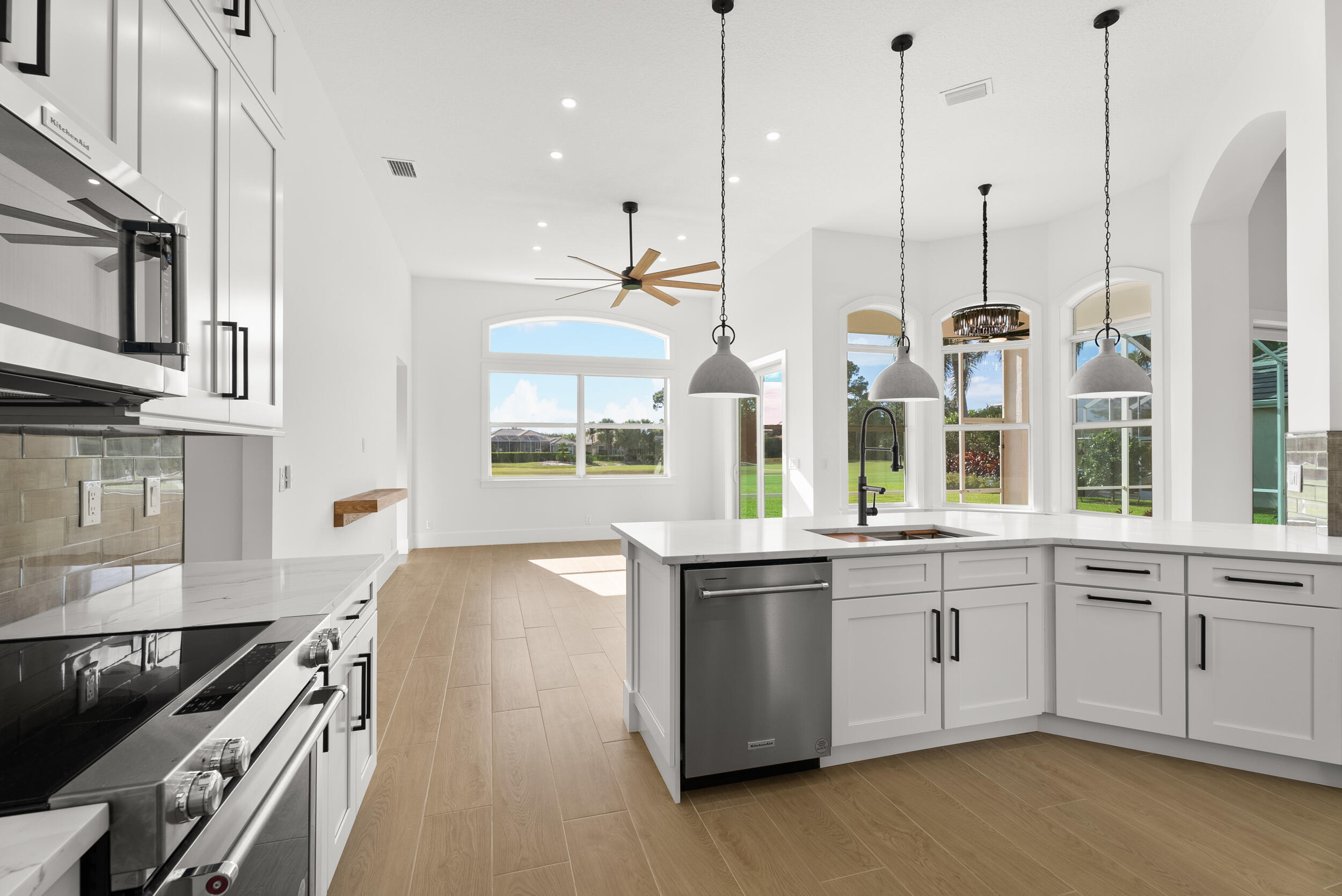 2218 Southeast Stonehaven Road Port St. Lucie, FL 34952 - Photo 20 of 48 a kitchen with stainless steel appliances granite countertop a stove a sink and a microwave