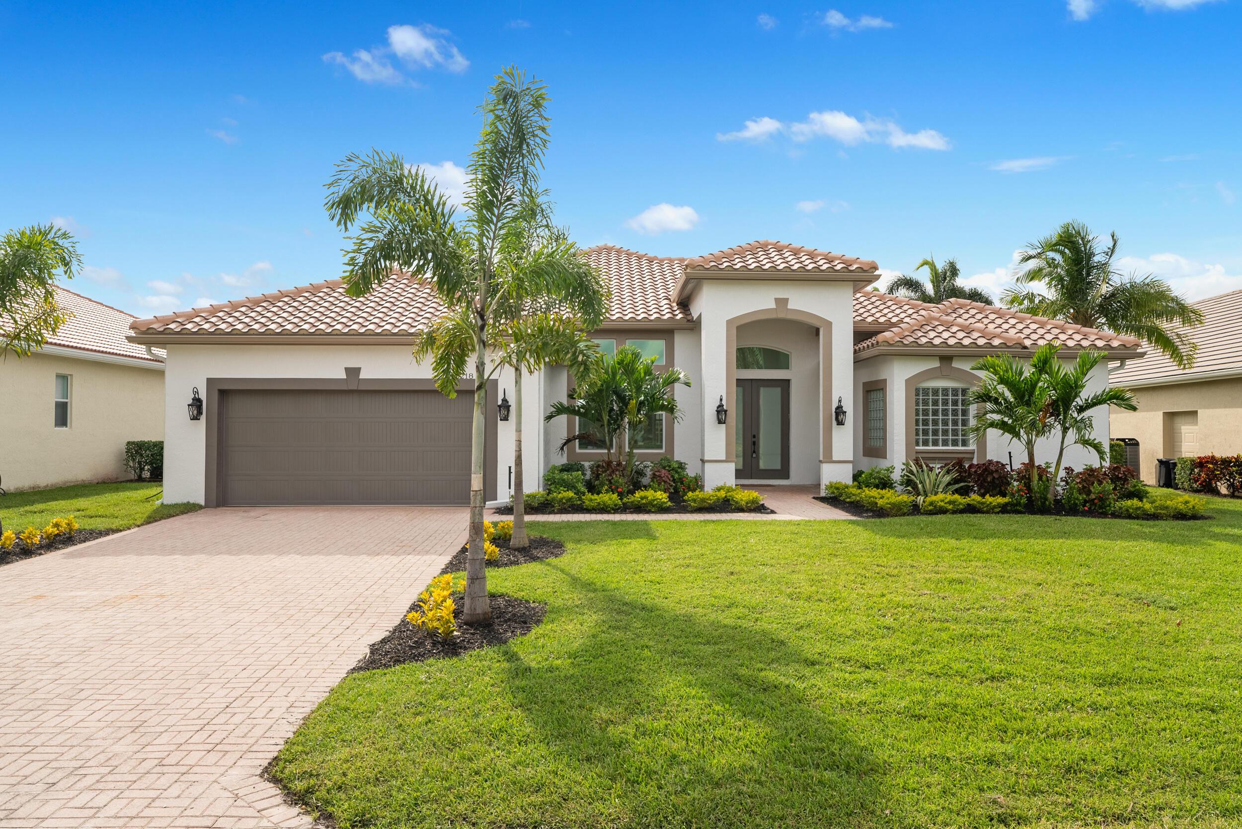 2218 Southeast Stonehaven Road Port St. Lucie, FL 34952 - Photo 2 of 48 a front view of a house with a garden and yard
