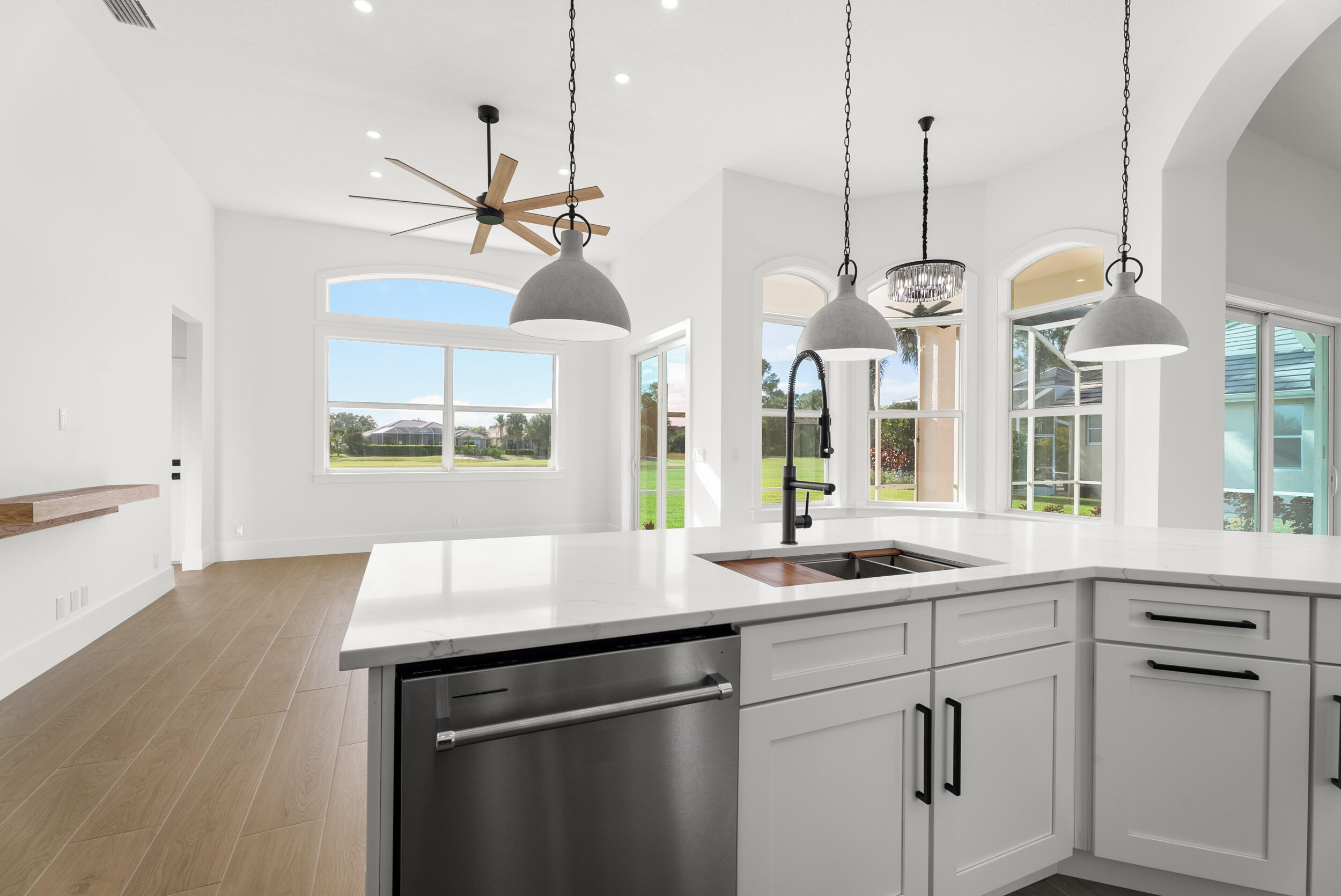 2218 Southeast Stonehaven Road Port St. Lucie, FL 34952 - Photo 21 of 48 a kitchen with stainless steel appliances granite countertop a sink a window and chairs