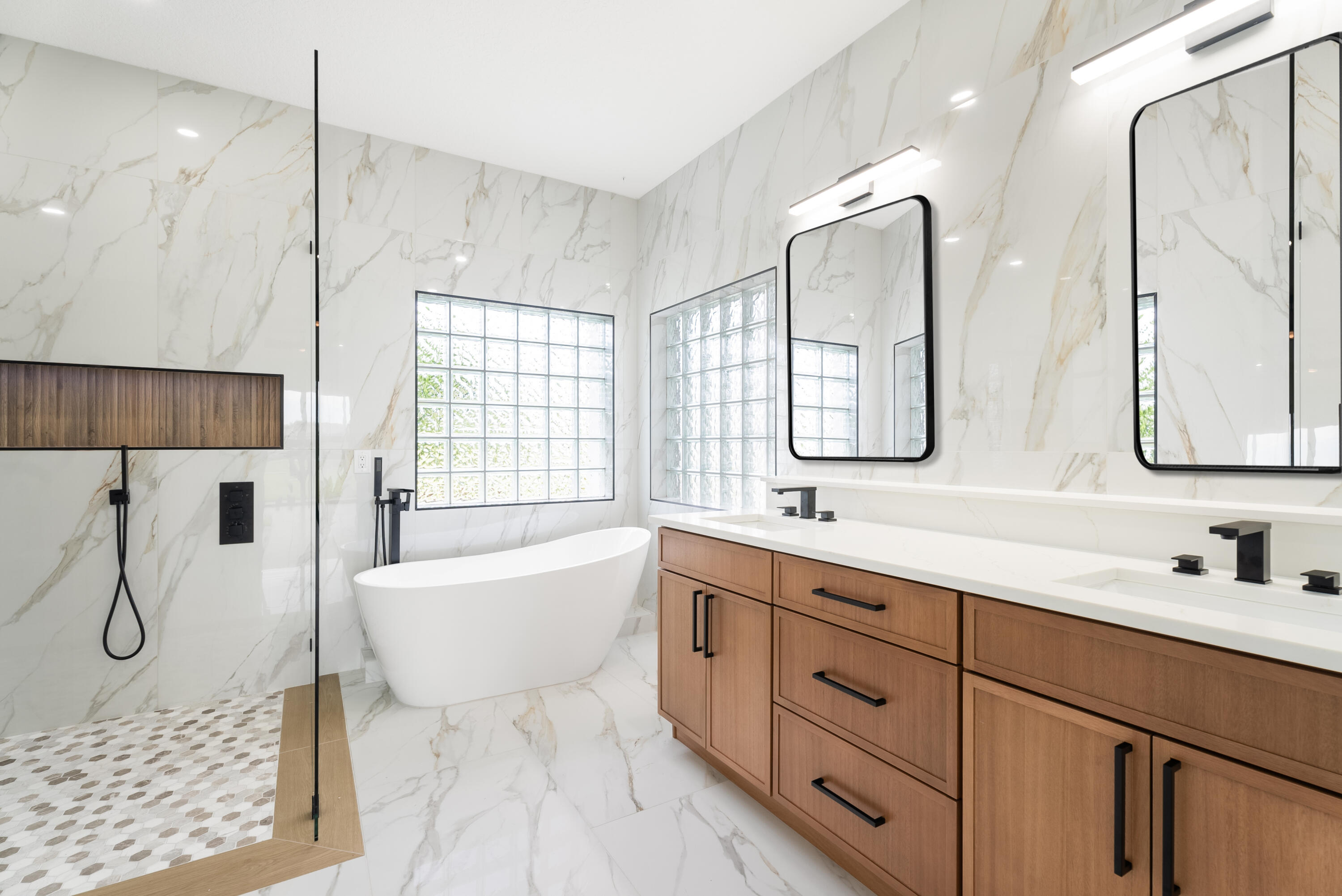 2218 Southeast Stonehaven Road Port St. Lucie, FL 34952 - Photo 28 of 48 a spacious bathroom with a double vanity sink a mirror a glass door and shower