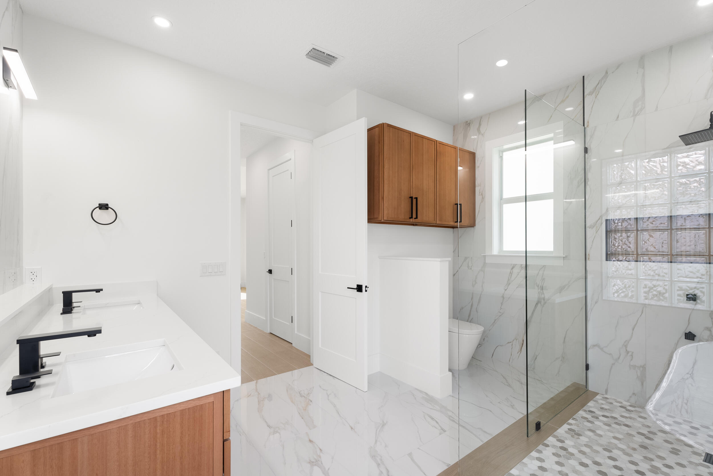 2218 Southeast Stonehaven Road Port St. Lucie, FL 34952 - Photo 30 of 48 a bathroom with a sink and glass door shower