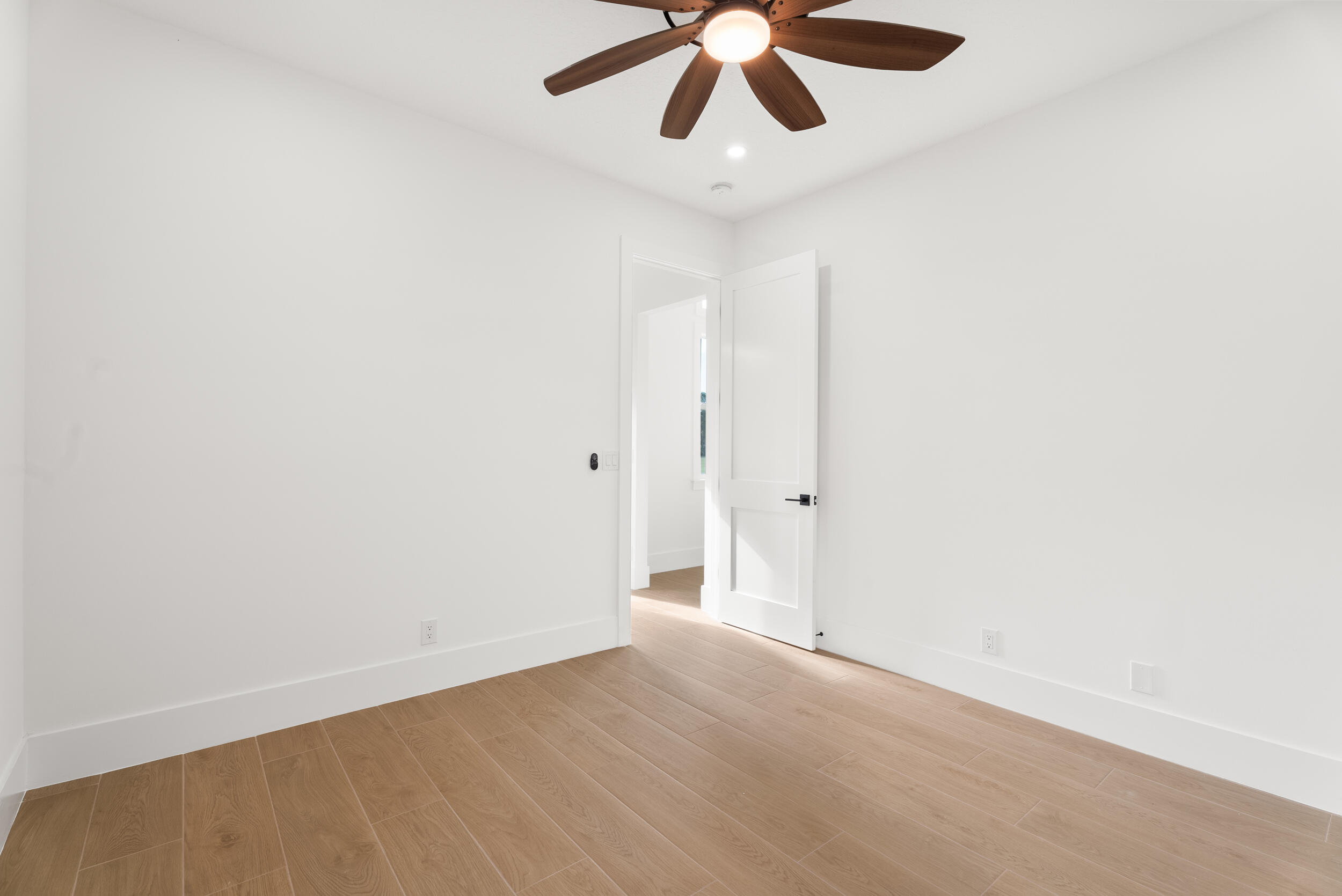 2218 Southeast Stonehaven Road Port St. Lucie, FL 34952 - Photo 35 of 48 an empty room with a ceiling fan and carpet