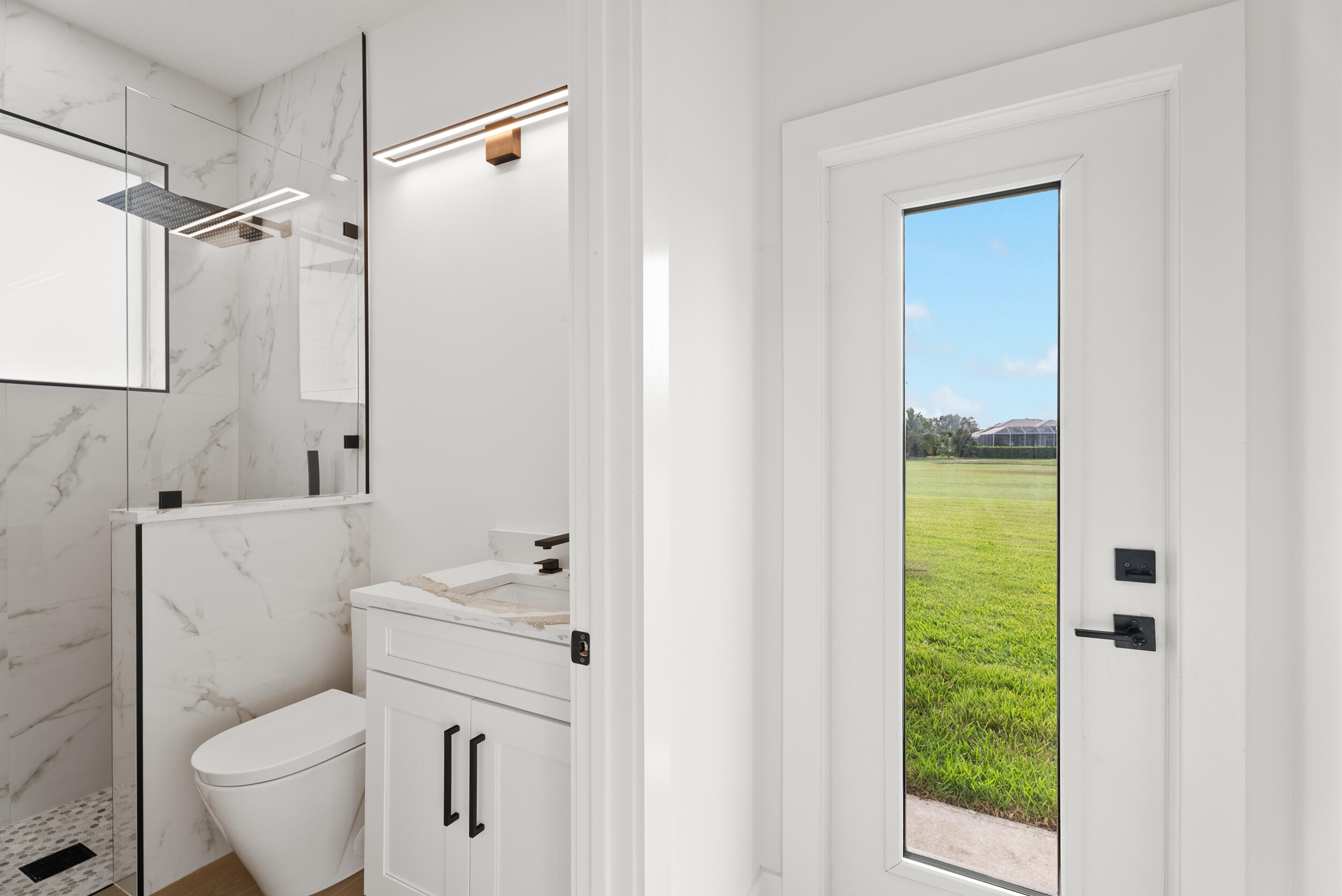 2218 Southeast Stonehaven Road Port St. Lucie, FL 34952 - Photo 36 of 48 a bathroom with a sink toilet and shower