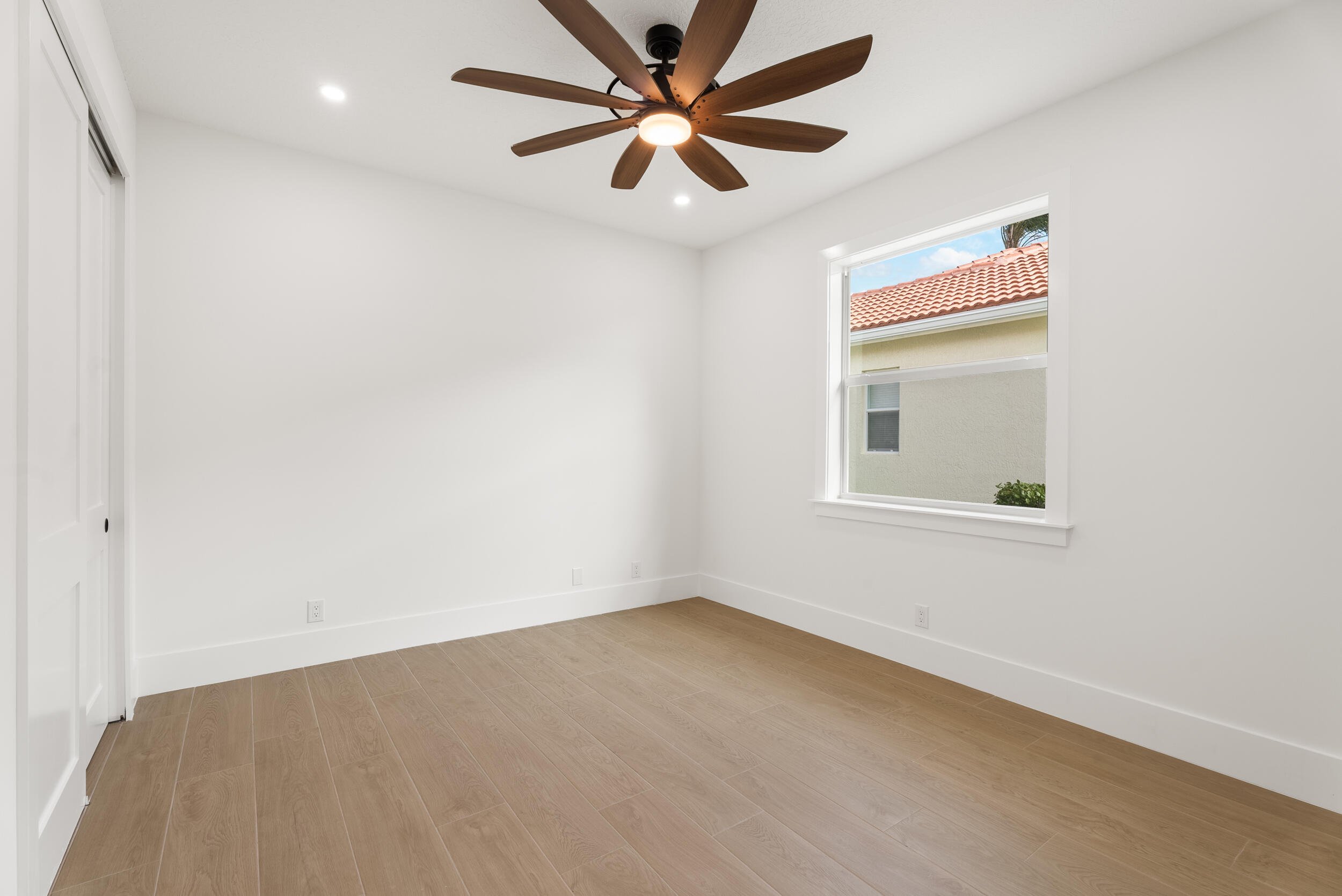 2218 Southeast Stonehaven Road Port St. Lucie, FL 34952 - Photo 38 of 48 an empty room with a window and a ceiling fan