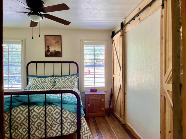 a bedroom with a bed and a potted plant