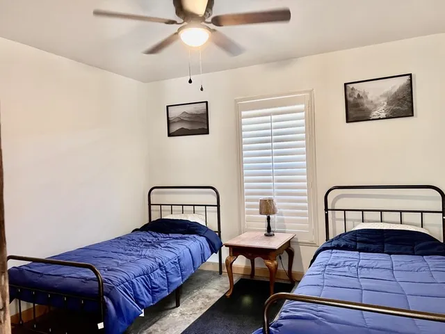 a room with a window and a table chair