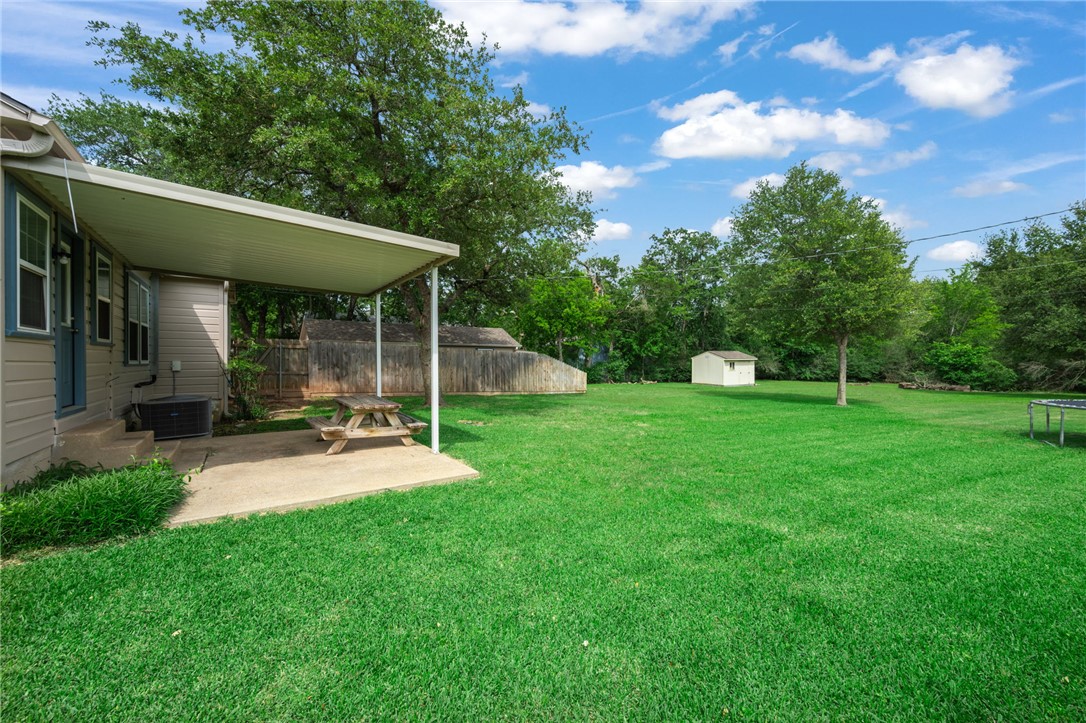 715 Inwood Drive Bryan, TX 77802 - Photo 8 of 34 a view of a house with backyard and sitting area