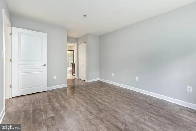 a view of an empty room and wooden floor