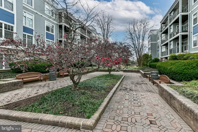 a front view of a building with a garden