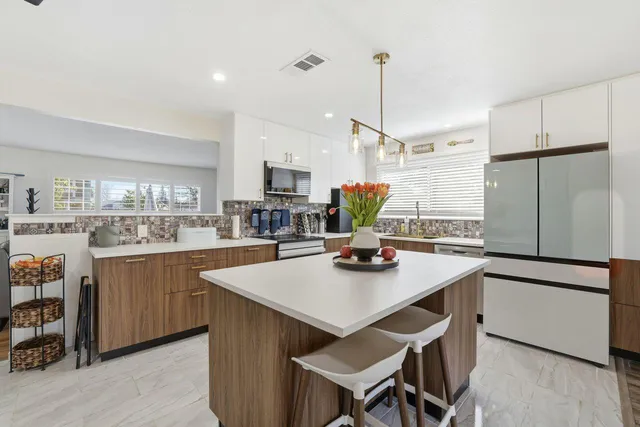 a kitchen with refrigerator cabinets and wooden floor