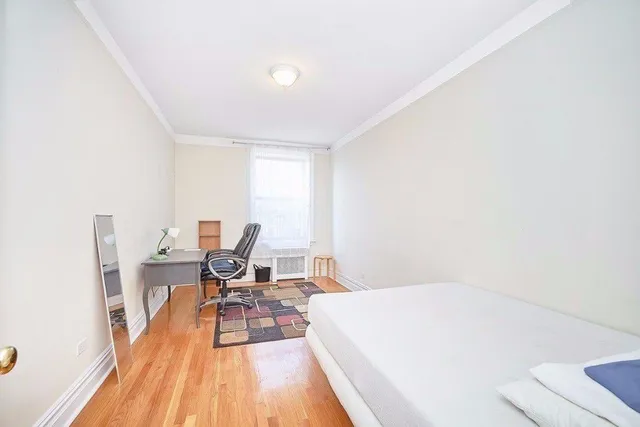 a view of a room with wooden floor and a chair