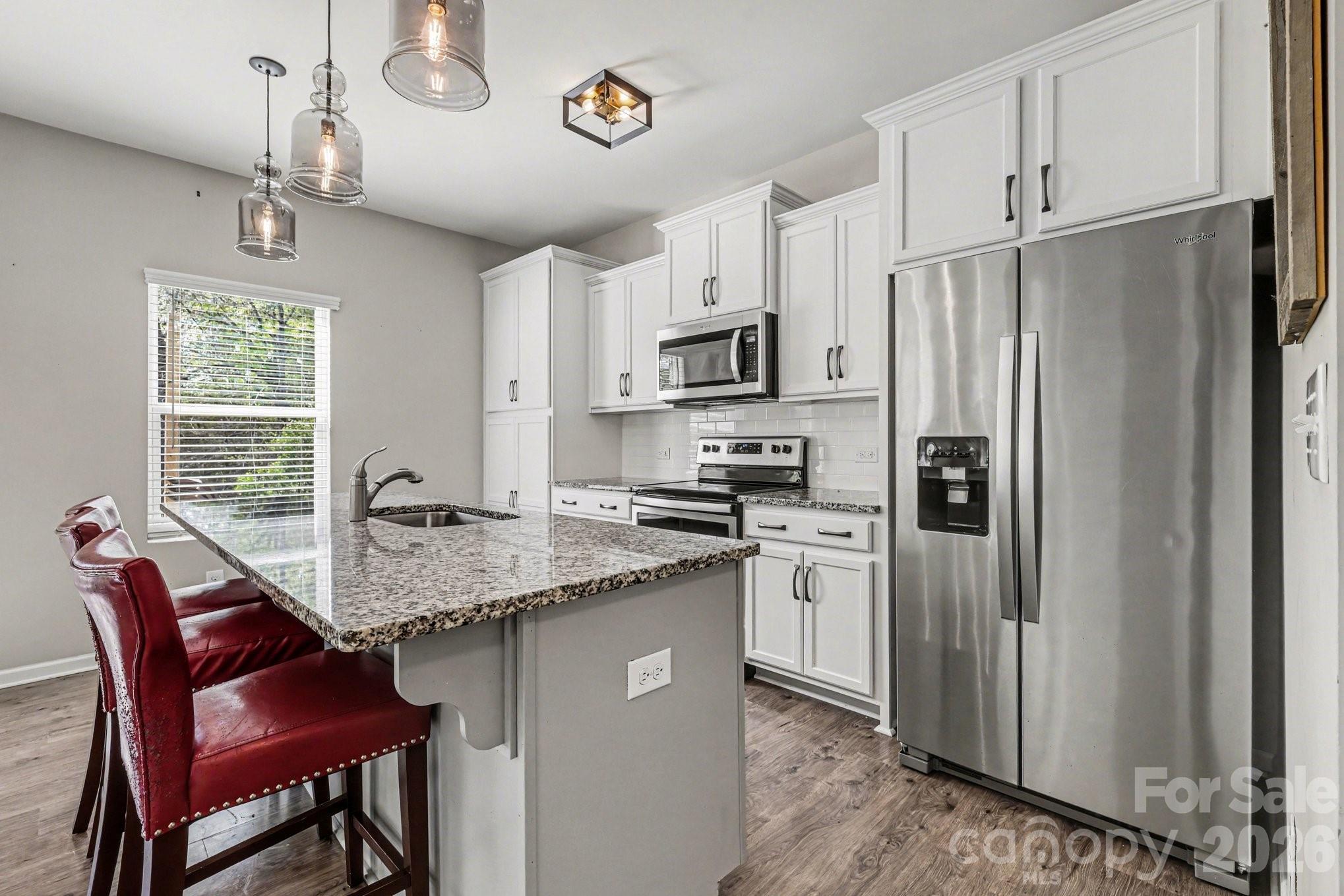 1158 Whitehall Hill Road York, SC 29745 - Photo 11 of 27 a kitchen with stainless steel appliances granite countertop a refrigerator a stove a sink and a granite counter tops