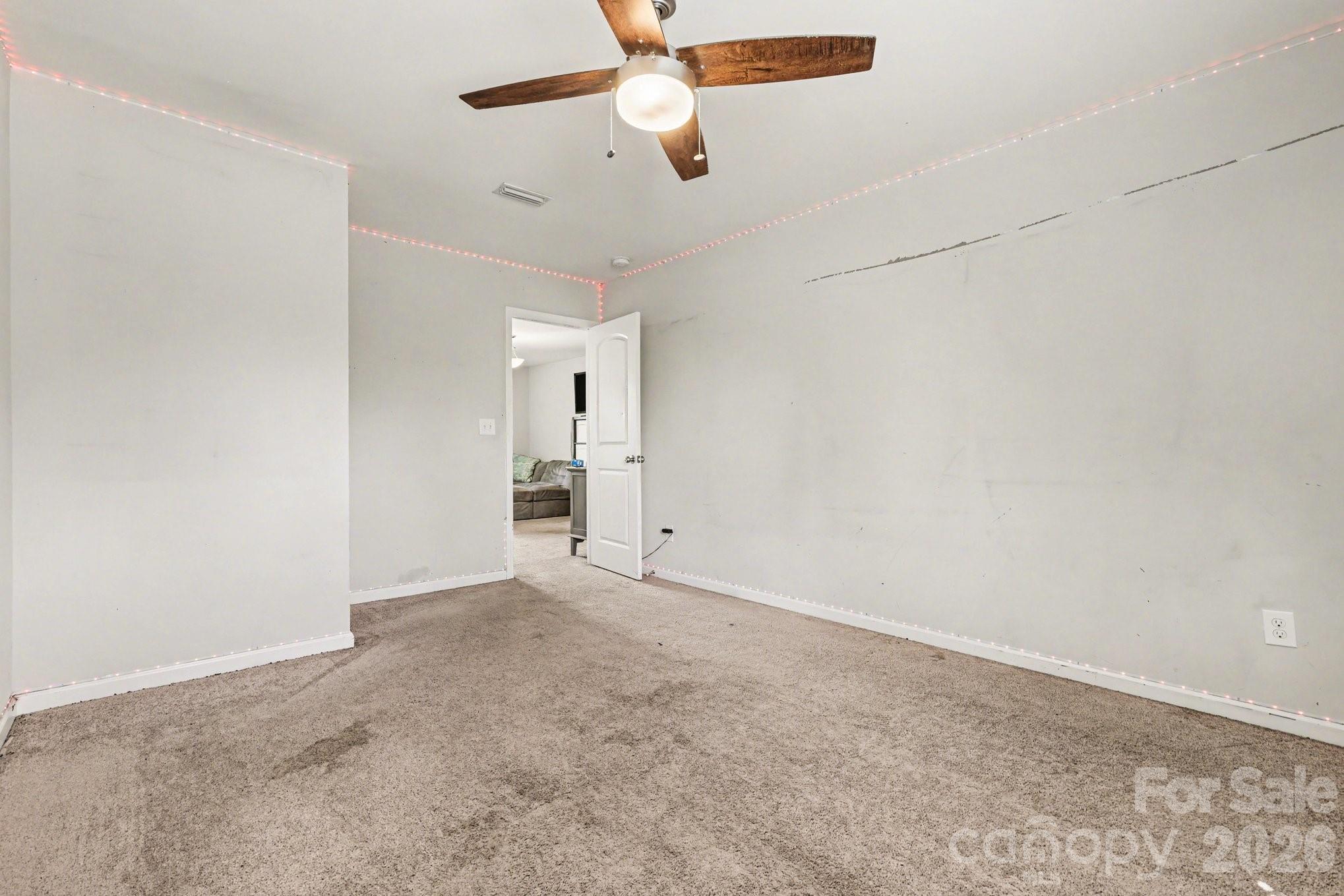 1158 Whitehall Hill Road York, SC 29745 - Photo 15 of 27 en empty room with ceiling fan and window