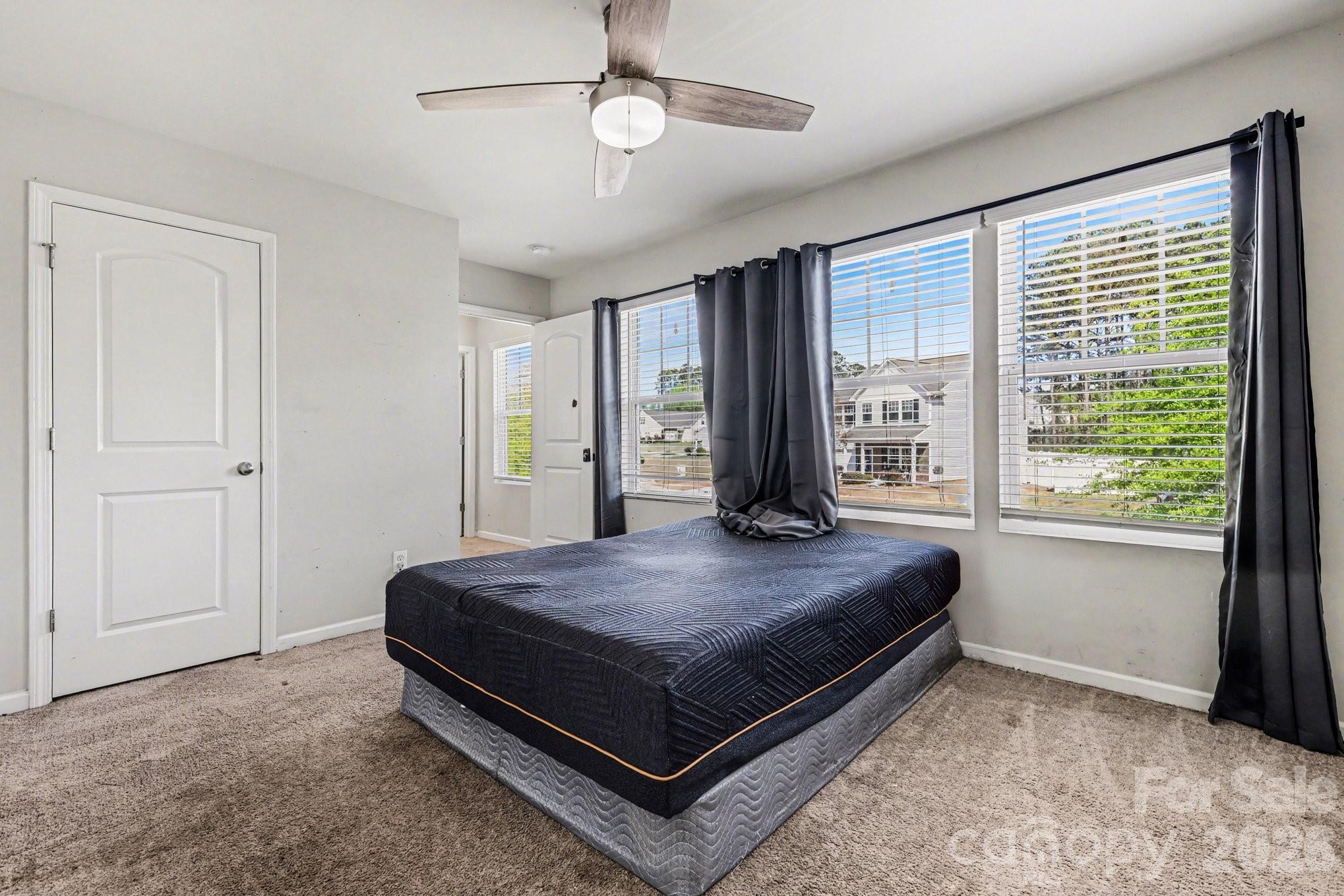 1158 Whitehall Hill Road York, SC 29745 - Photo 16 of 27 a bed sitting in a spacious bedroom next to a window
