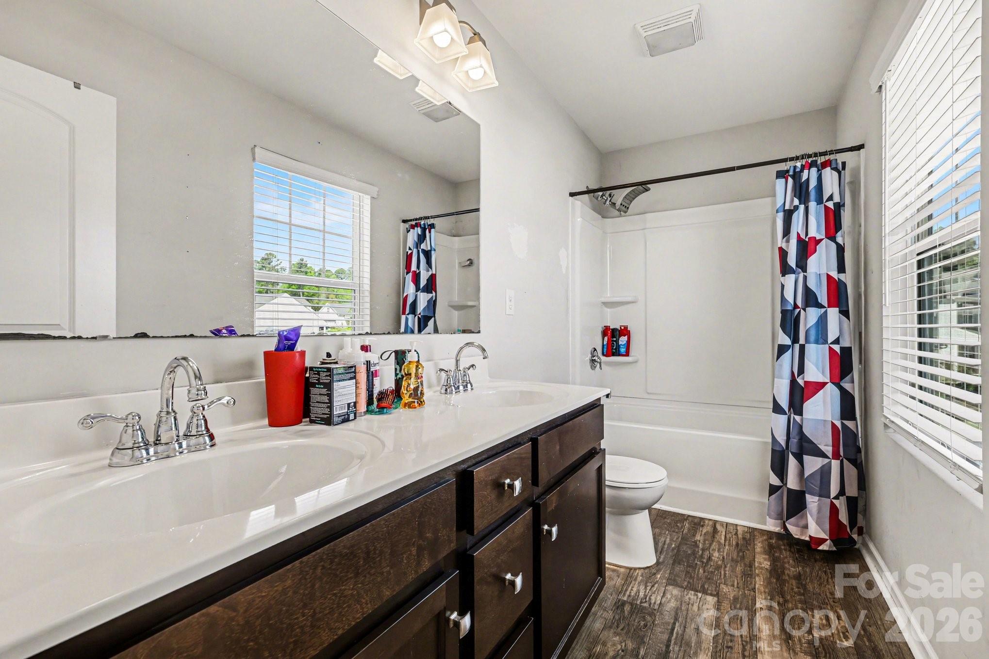 1158 Whitehall Hill Road York, SC 29745 - Photo 17 of 27 a bathroom with a sink a toilet a shower curtain and a large mirror