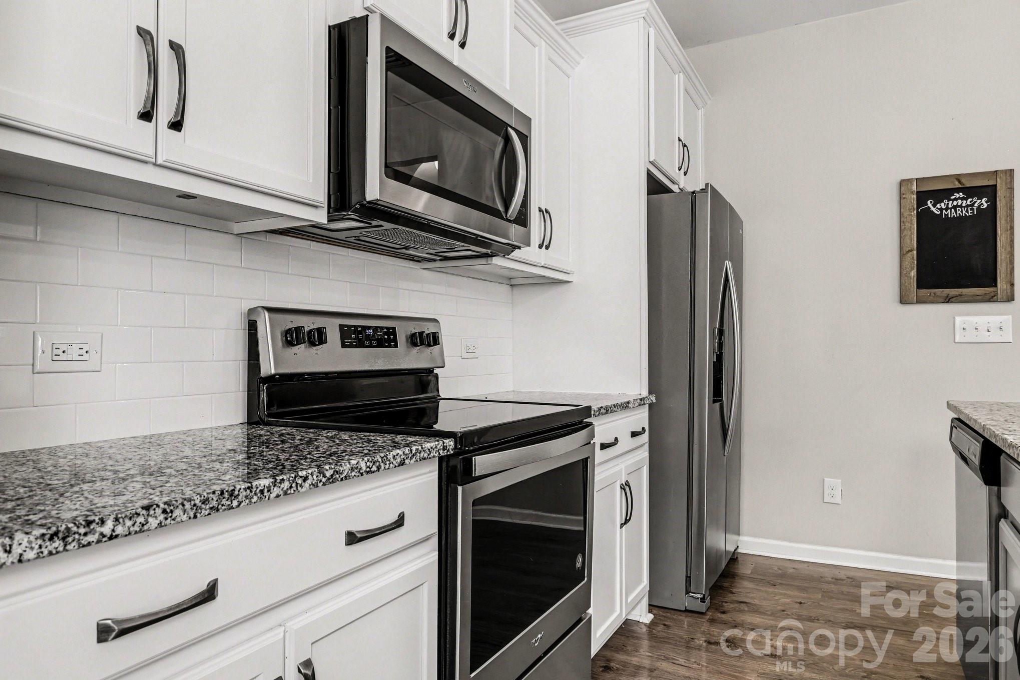 1158 Whitehall Hill Road York, SC 29745 - Photo 10 of 27 a kitchen with stainless steel appliances granite countertop a stove microwave and refrigerator