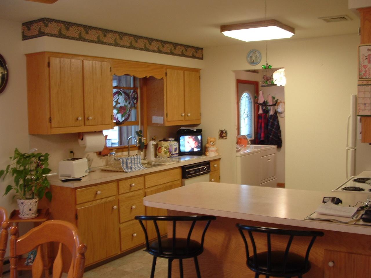 18 Cedar Road Mount Pocono, PA 18344 - Photo 5 of 8 a kitchen with a table chairs refrigerator and microwave