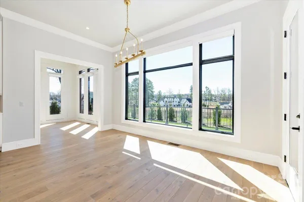 a view of a kitchen from an empty room and fire place
