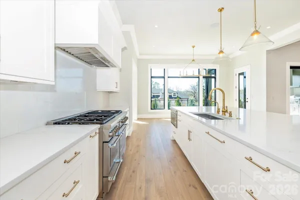 a kitchen with cabinets a sink and appliances