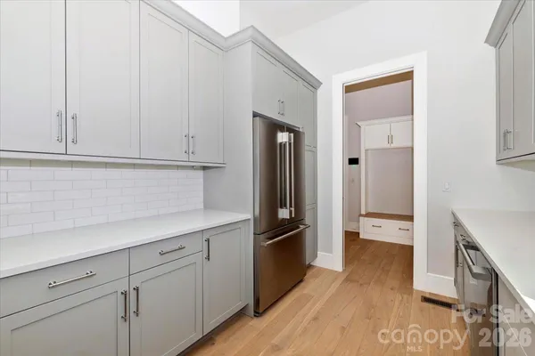 a spacious bathroom with a double vanity sink mirror and a bathtub