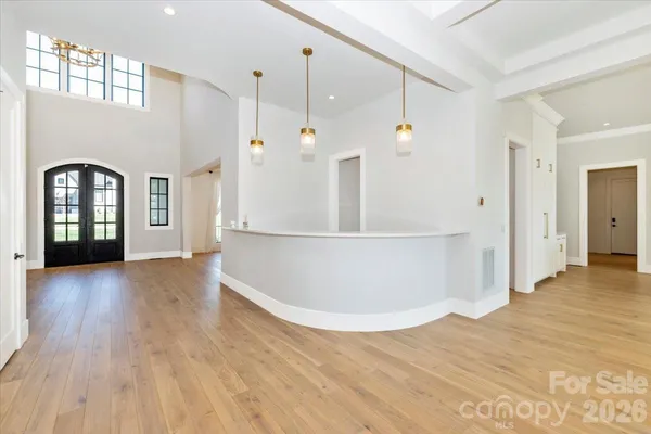 a view of a kitchen with wooden floor and window