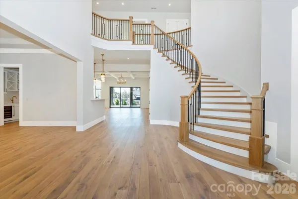a view of entryway and hall with wooden floor
