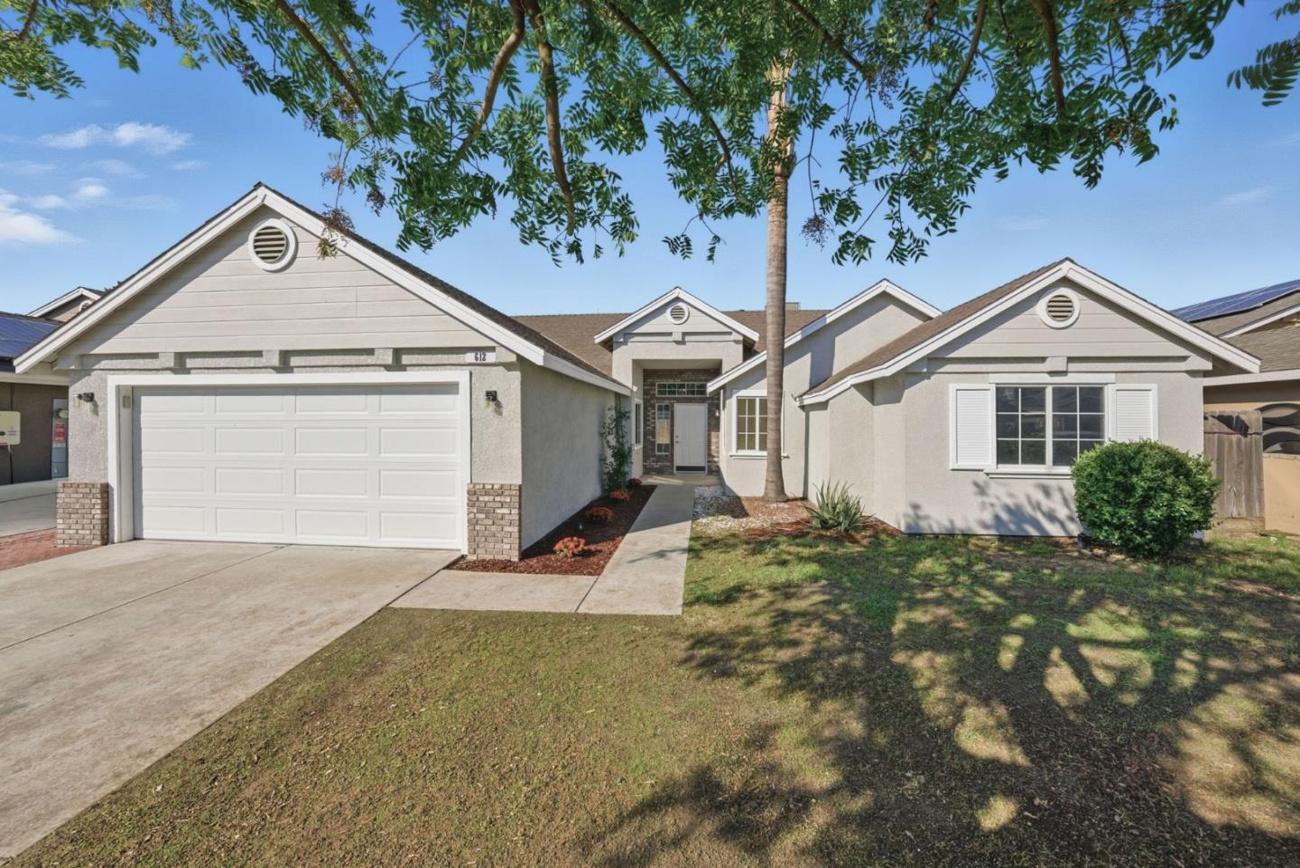 612 Saffron Street Hanford, CA 93230 - Photo 1 of 1 a view of a house with a yard and potted plants