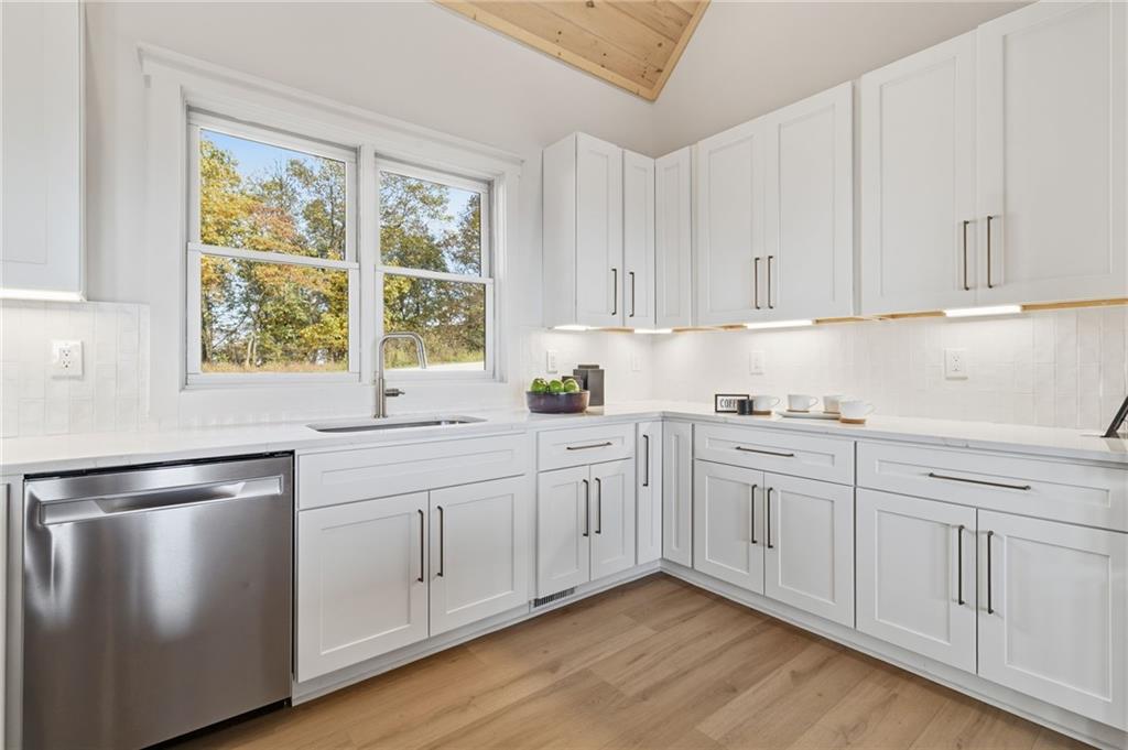 5510 Monument Road Jasper, GA 30143 - Photo 11 of 58 a kitchen with granite countertop white cabinets and white appliances