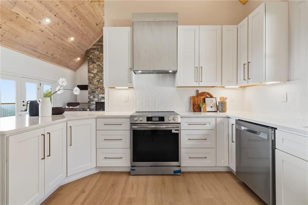 5510 Monument Road Jasper, GA 30143 - Photo 13 of 58 a kitchen with white cabinets and white appliances
