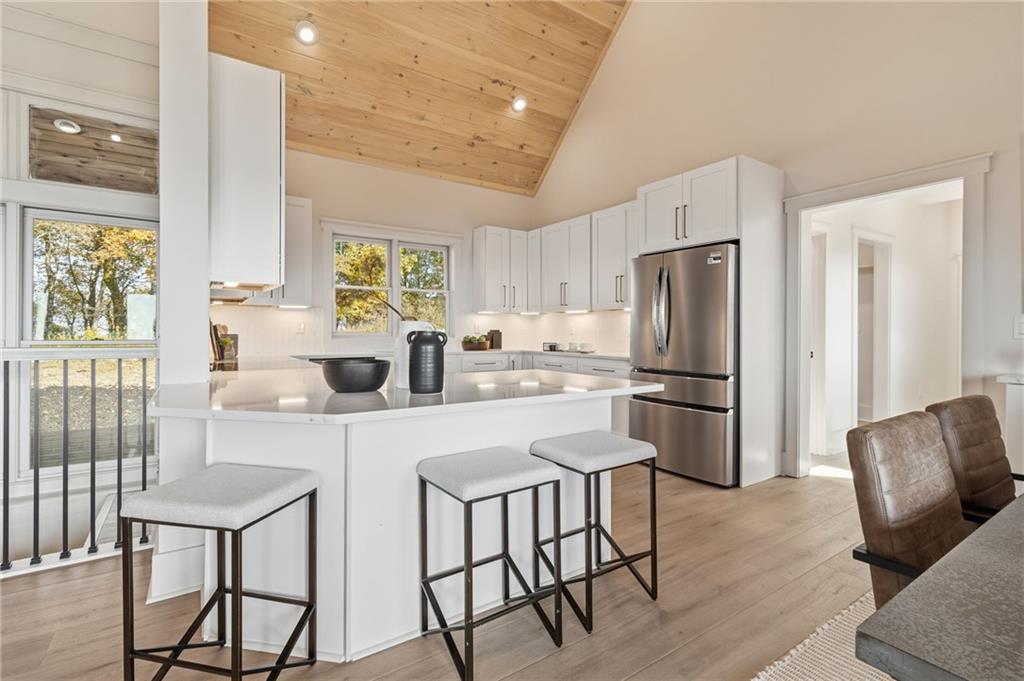 5510 Monument Road Jasper, GA 30143 - Photo 14 of 58 a kitchen with stainless steel appliances a refrigerator a stove a dining table and chairs